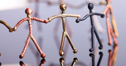 metal stickmen in circle joined at the hands