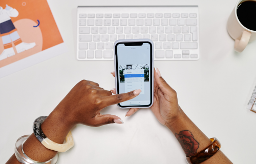 Person using a mobile phone at their desk